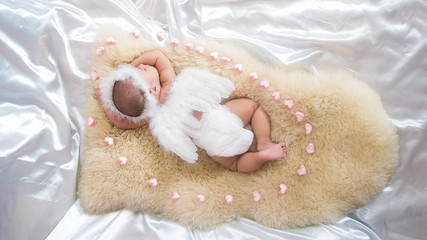 cute asian four-month baby in cupid dress sleeping