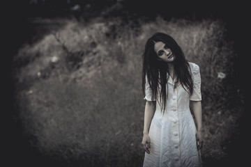 Fototapeta premium Portrait of asian woman make up ghost face at the swamp,Horror scene,Scary background,Halloween poster,Thailand people