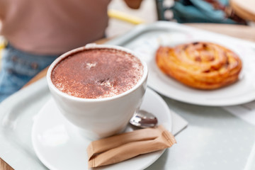 coffee and cake snail on the table in the cafe