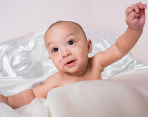 cute asian four-month baby in cupid dress smiling