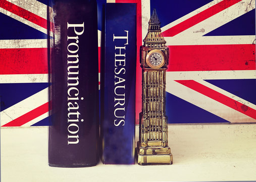 English language thesaurus and pronunciation dictionary near a tacky Big Ben reproduction on a grunge Union Jack background