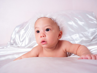 cute asian four-month baby in cupid dress smiling