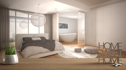 Wooden table, desk or shelf with potted grass plant, house keys and 3D letters home sweet home, over minimal bedroom with bathroom, architecture interior design, copy space background