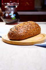Rye bread with seeds lying on a wooden Board