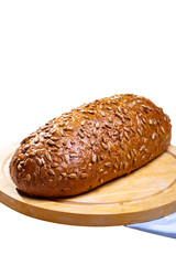 Rye bread with seeds lying on a wooden Board