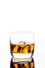 Glass of whiskey with ice on a white background. White background. Whiskey / Brandy / Cognac / Rum. Glass with a strong drink.