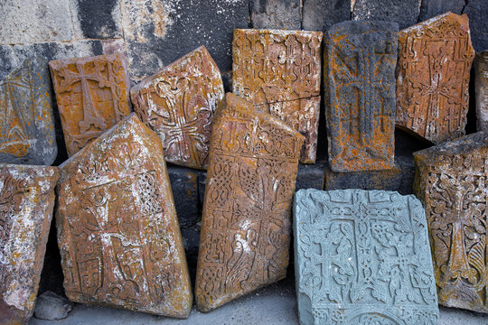 ancient slabs of old Sevanavank monastery. Armenian shrines stand against the wall in the monastery