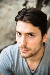 Fototapeta premium Portrait of young male model with serious face looking at camera, casual clothes.
