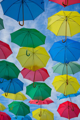 Fototapeta na wymiar Umbrellas of different colors in the sky like balloons