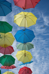 Umbrellas of different colors in the sky like balloons