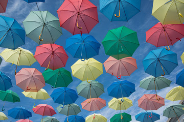 Fototapeta na wymiar umbrella of different colors flying in the sky, copy-space