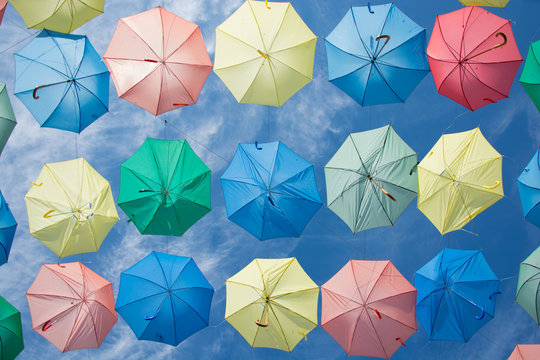 umbrella of different colors flying in the sky, copy-space