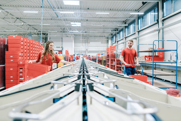 People working on sorting line in mail distribution center