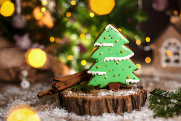 Holiday traditional food bakery. Gingerbread green christmas tree in cozy warm decoration with garland lights