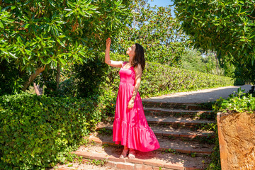 Girl in red dress in green park