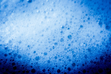 Beautiful abstract texture color white and blue bubbles background in water on blue background pattern clear soapy shiny