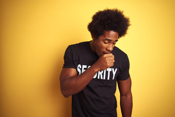 Fototapeta na wymiar American safeguard man with afro hair wearing security uniform over isolated yellow background feeling unwell and coughing as symptom for cold or bronchitis. Healthcare concept.