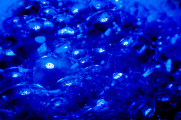 Beautiful abstract texture color white and blue bubbles background in water on blue background pattern clear soapy shiny