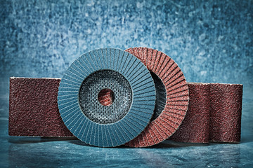 flap discs and abrasive tapes on metalic background