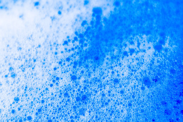 Beautiful abstract texture color white and blue bubbles background in water on blue background pattern clear soapy shiny