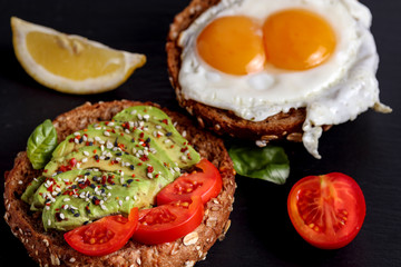 Avocado egg rye toast. Healthy vegetarian sandwich. Vegan burger with tomato, basil,chili and sesame. Fresh fitness recipe. Gourmet lunch dish. Simple health raw food. Meal on focus