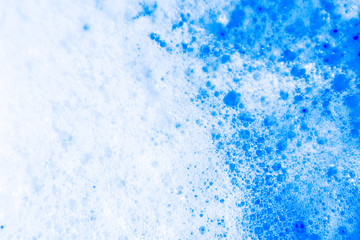 Beautiful abstract texture color white and blue bubbles background in water on blue background pattern clear soapy shiny