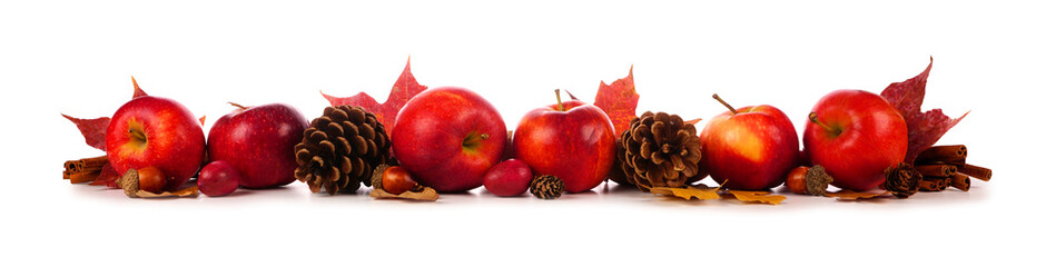 Autumn border of apples, leaves, and fall decor. Side view isolated on a white background.