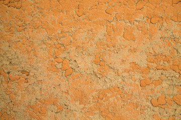 Texture of old rustic wall covered with yellow stucco