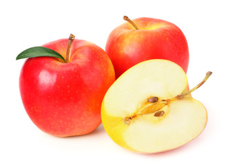 red apples with slices and green leaves isolated on a white background