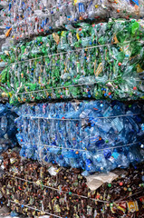 Green plastic PET bottles pressed in bales for recycling