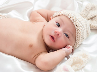 cute newborn three-month baby in lovely action
