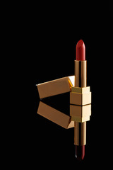 Lipstick. Fashion colorful lipstick on black background with reflections. Professional makeup and beauty. Beautiful makeup concept. Copy spase.
