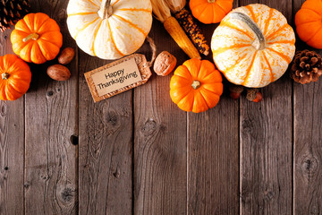 Happy Thanksgiving tag with autumn top border of pumpkins and fall decor on a rustic wood...