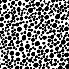 Abstract seamless pattern with black circles. Polka dot pattern. Animal print. Vector hand drawn texture with different sized circles. Illustration for wrapping paper, textile print.