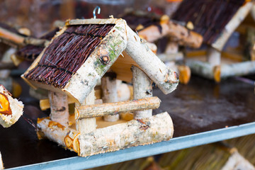 Bird feeder in the form of a wooden house on market in Germany
