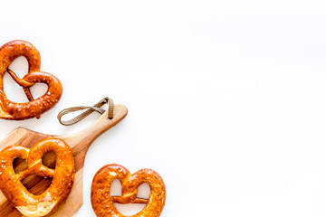 Octoberfest symbol. Fresh bavarian pretzels on white background top view copy space