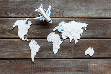 Planning a travel concept. Sketchy map of the world on dark wooden background top view