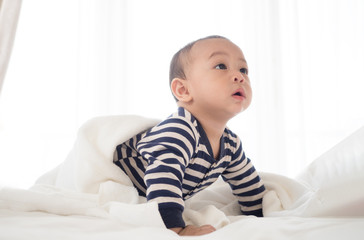 cute asian seven month baby in white dress smiling