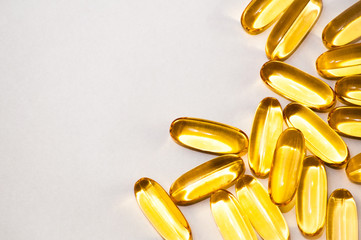 Close up of food supplement oil filled capsules suitable for: fish oil, omega 3, omega 6, omega 9,...