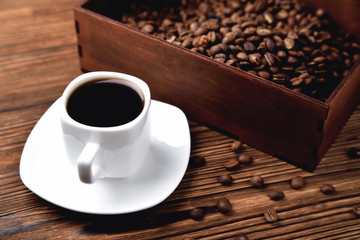 light coffee beans wooden box with coffee, natural wooden background