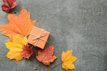 Autumn composition. Maple leaves and gift box. Flat lay, top view