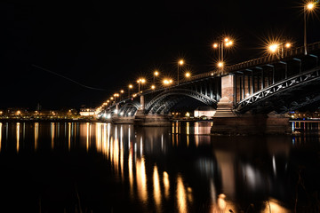 Fototapeta na wymiar Lightreflections at Rhine / Rhein river at an old bridge in Mainz near Frankfurt am Main, Germany.