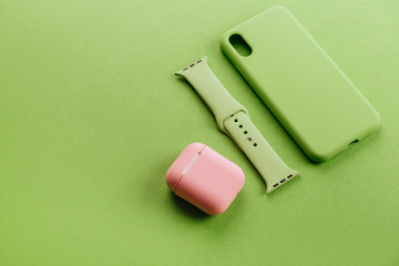 Up to date technology.Top view of diverse personal accessory laying on the green background