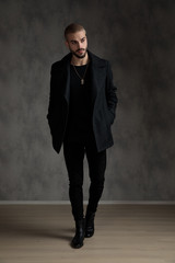 attractive young fashion man wearing black longcoat
