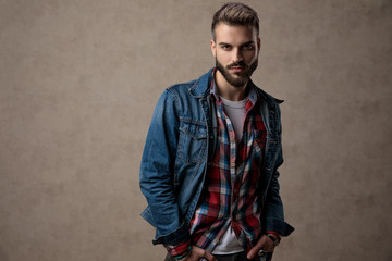 arrogant young fashion model wearing blue denim jacket
