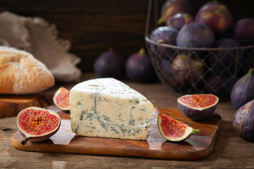 blue cheese with fresh figs on wooden board