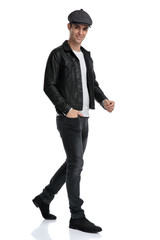 casual man walking with hand in pocket happy