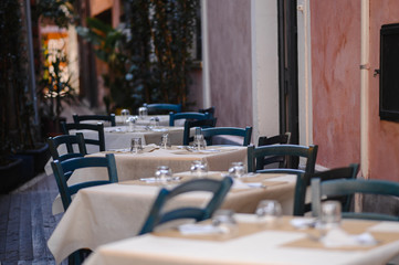 Cafe tables and chairs outside a quaint stone building
