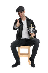 seated casual man holding cup with a ok sign confident