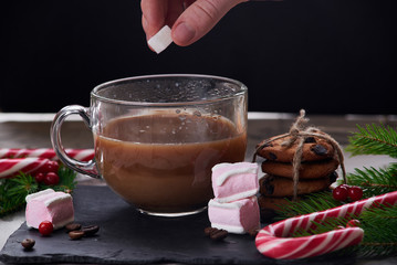 Coffee with milk preparation in glass cup with marshmallow